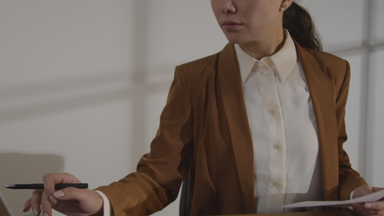 Businesswoman In Office Reviewing And Making Notes On Application Or CV For Job Vacancy 2