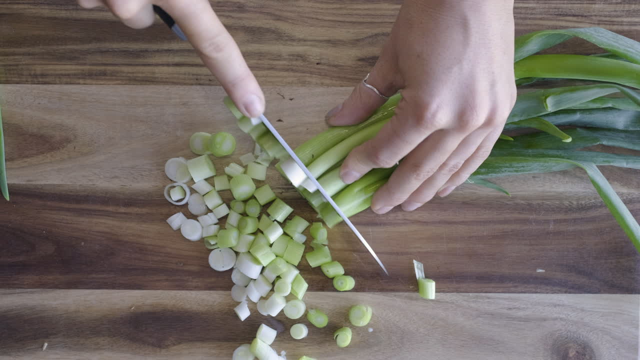 Overhead shot of person cutting up spring onions