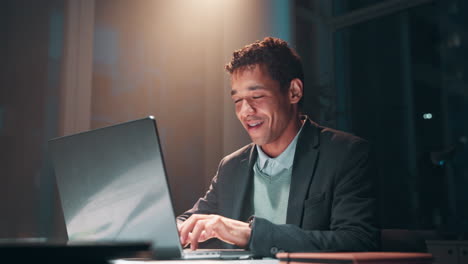 a man working on a laptop in an office