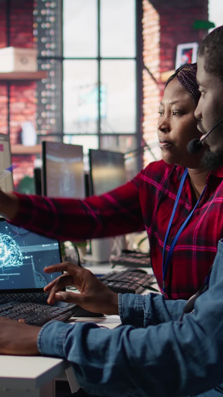 Vertical video Call center manager teaches intern how to use AI to enhance customer interaction