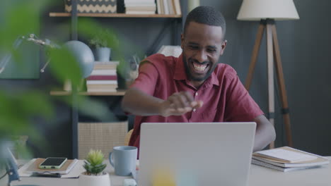 happy man celebrating success at home office