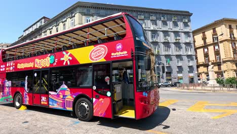 red double-decker bus in naples, italy