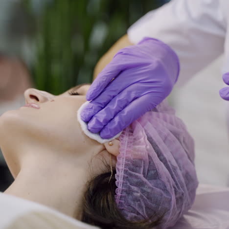 beauty clinic. beautician hands in gloves making face anti-aging injection in a female neck. a woman gets beauty facial cosmetology procedure. botox.