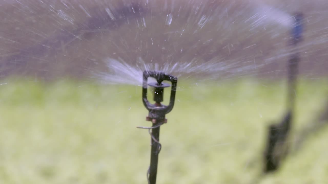 Farming sprinkler system spraying out water in all directions