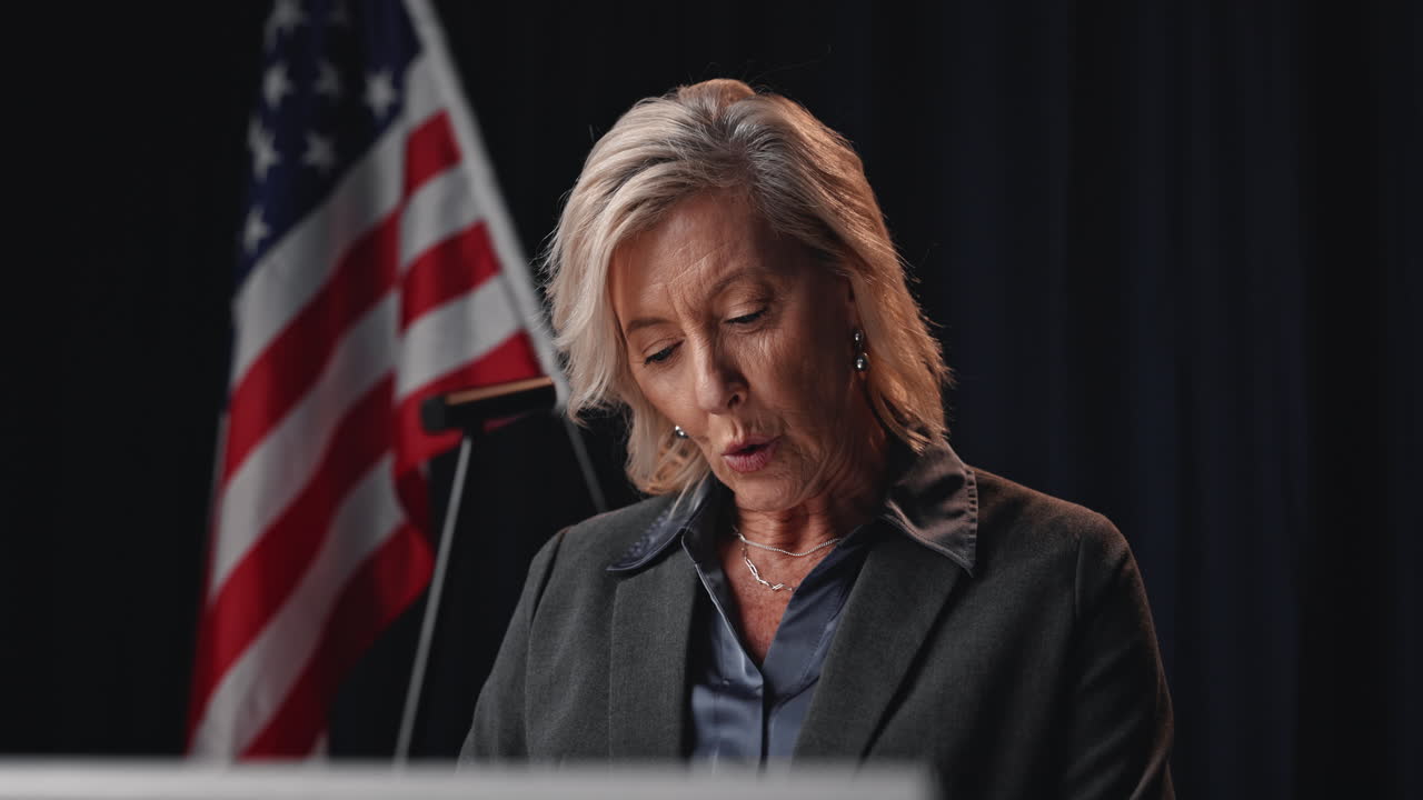 Woman giving a speech in front of an American flag