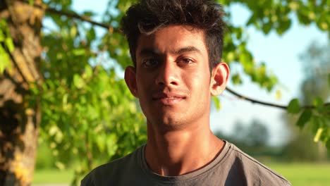 male model in park, portrait closeup with confident asian man