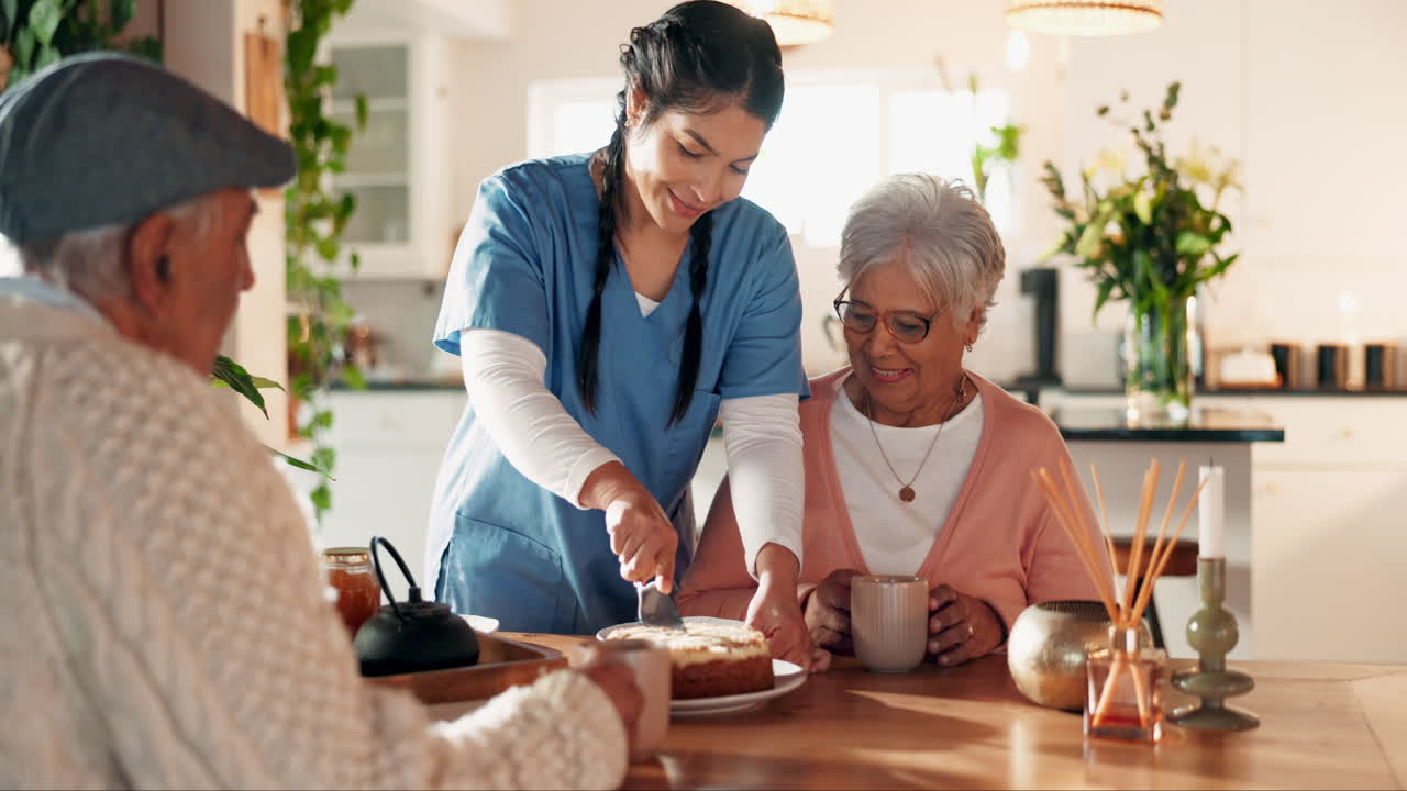 A caregiver helps an elderly woman cut a slice of cake.