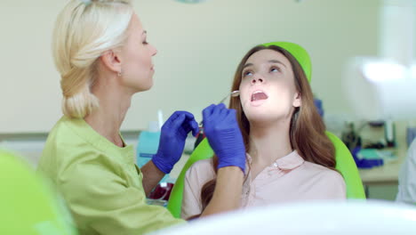 Regular-dental-checkup-at-dentist-office.-Happy-woman-on-dental-chair