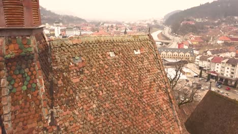 a drone shot, with forward motion, capturing a glimpse of the city of sighisoara on an afternoon