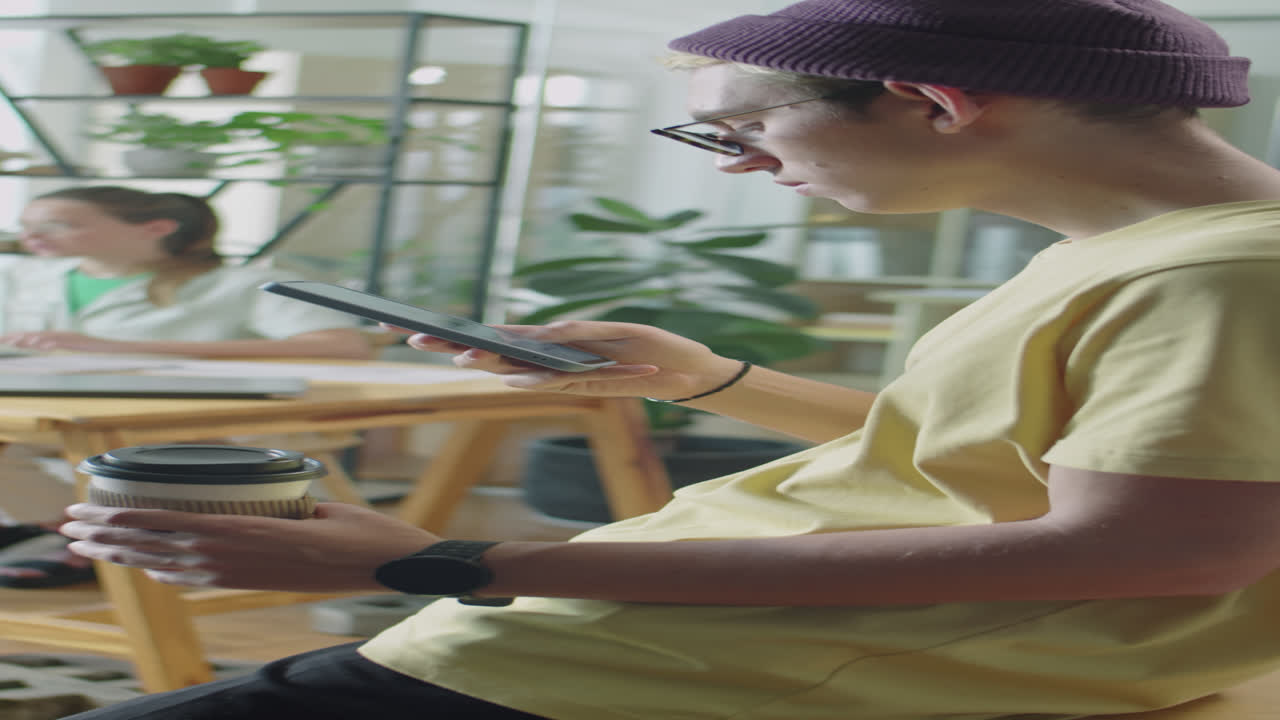 Gen Z Office Worker Holding Coffee and Scrolling on Phone