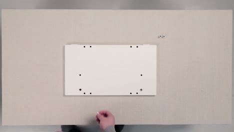 installing a white panel on a tabletop