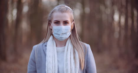 woman putting on protective mask against coronavirus 5