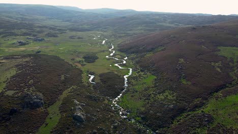 aerial panoramic overview of winding river moving across segundera mountains in zamora spain