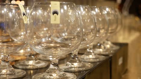 close up footage of wine glasses displaying on the shelf at mall