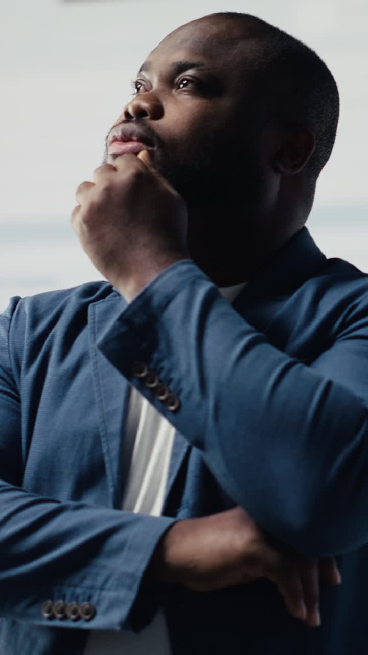 African American Man Thinking and Contemplating in a Modern Office