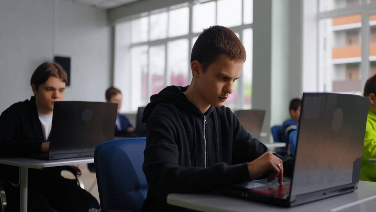 Students in a classroom working on laptops