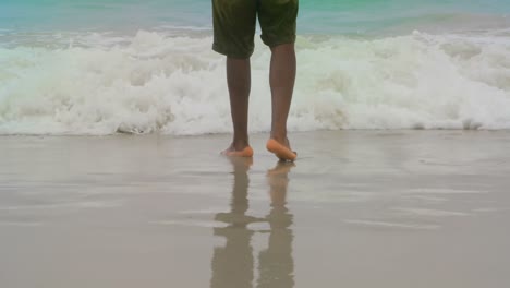 low section of man standing on the beach 4k