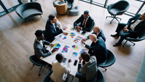 business professionals collaborating and analyzing data in a meeting