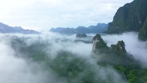 misty green mountains are seen in thailand