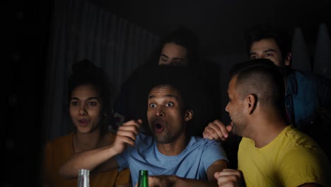 video of excited friends watching tv at night