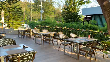 quiet restaurant patio with empty tables and chairs