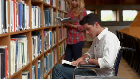 estudiante discapacitado leyendo en la biblioteca