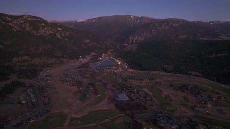 drone aerial view of big sky golf resort at night in montana