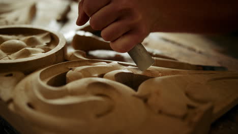 woodworker carving wood in carpentry workshop