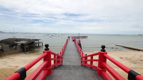 long red japanese styled sea bridge lays into the sea