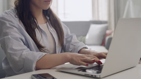 journalist typing a story on a laptop