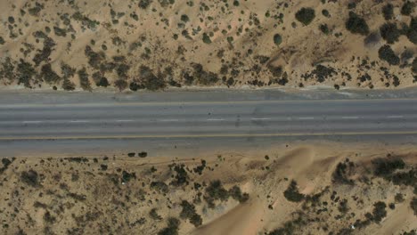 aerial looking down on empty road through desert landscape in balochistan