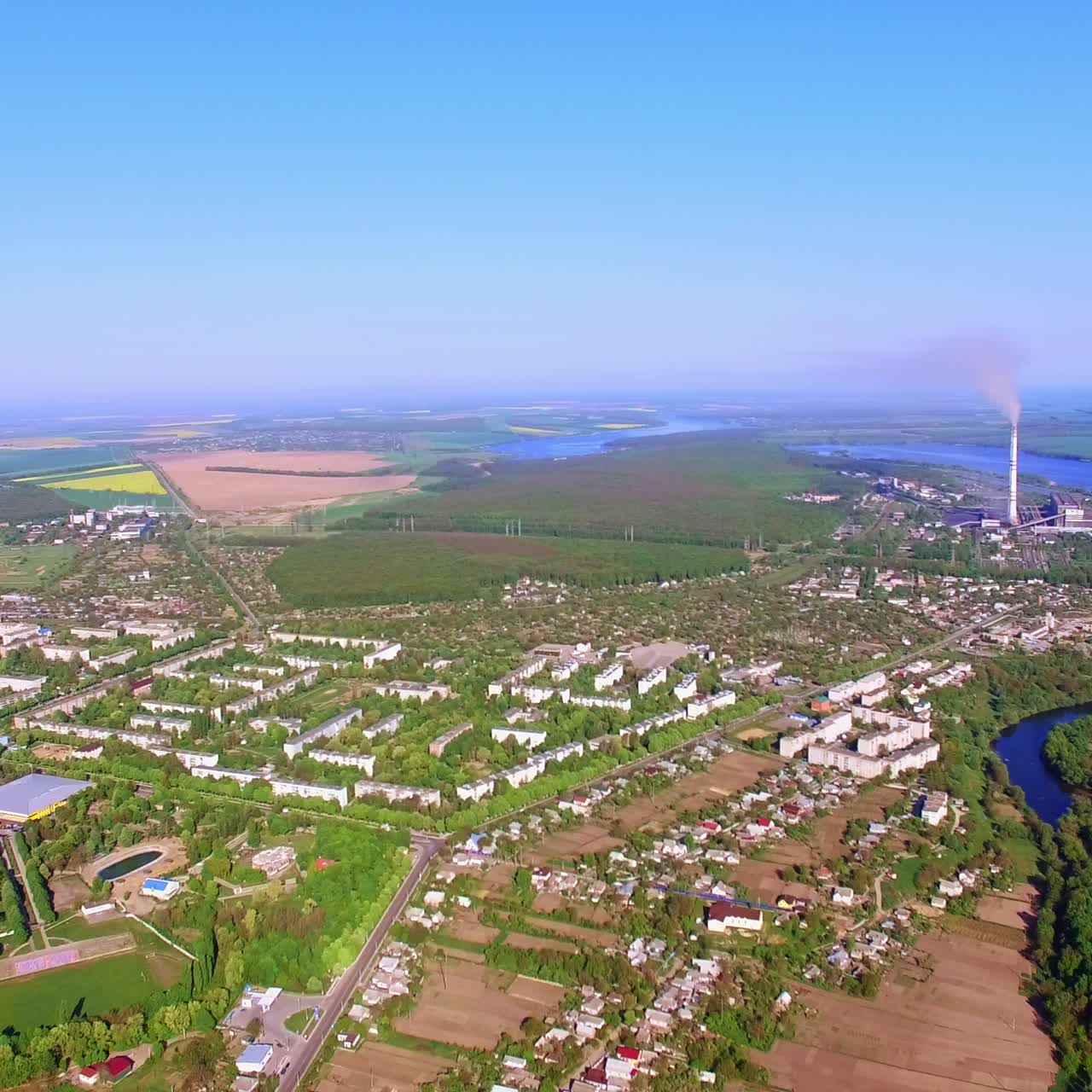 Amazing scenery of a city situated on the banks of beautiful river. Sunny day shot at the backdrop of blue clear sky