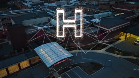 twilight over a hospital er entrance, with a glowing holographic 'h' and geometric shapes above