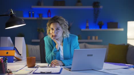 Home-office-worker-woman-looking-at-camera-depressed.