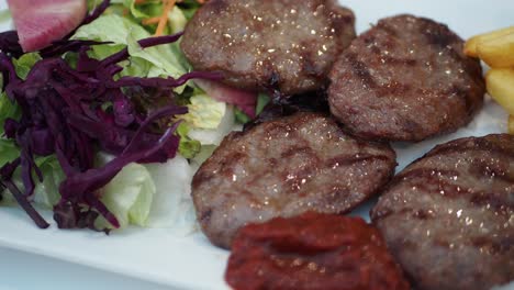 turkish kofta with fries and salad