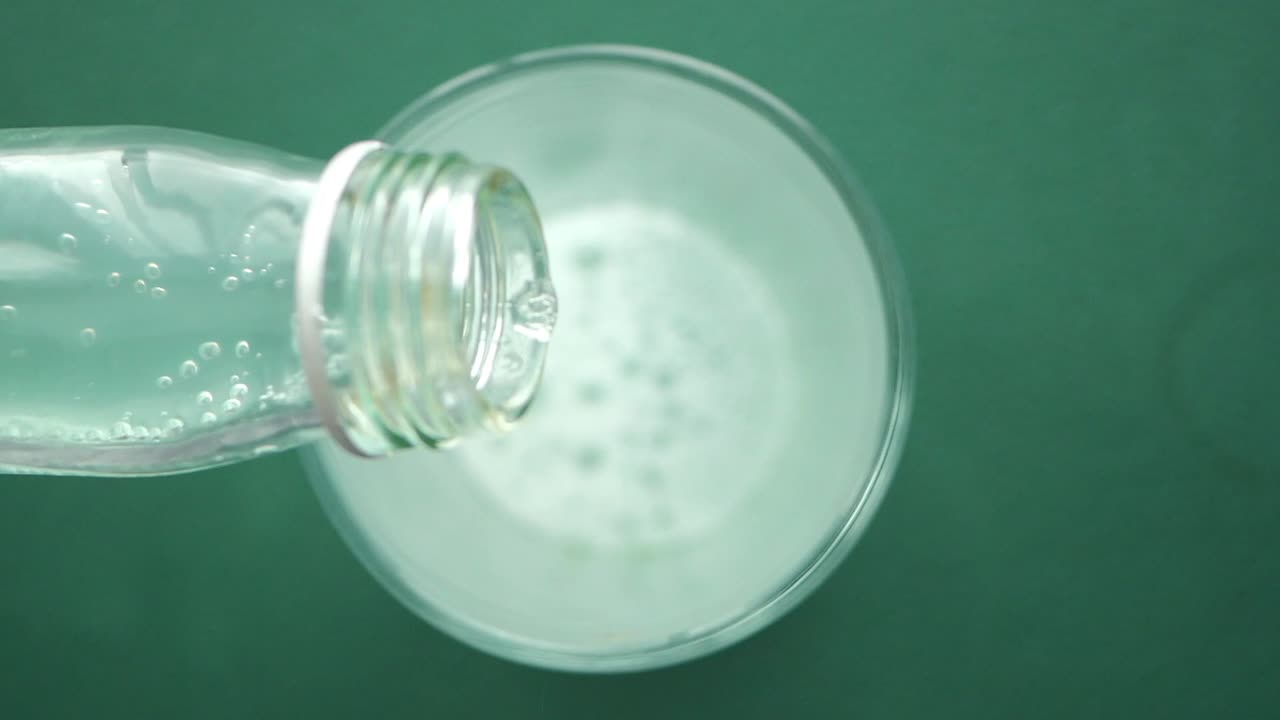 Lemonade pouring into a glass