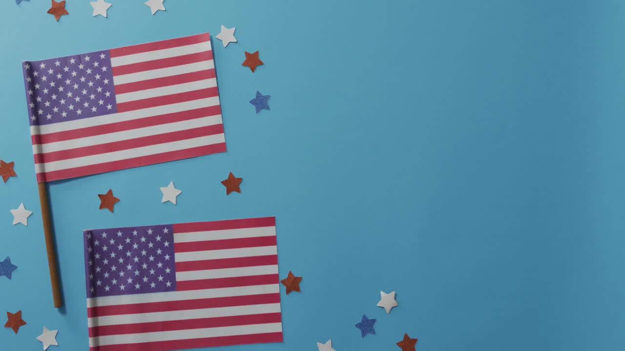 American flags with red and blue stars lying on blue background