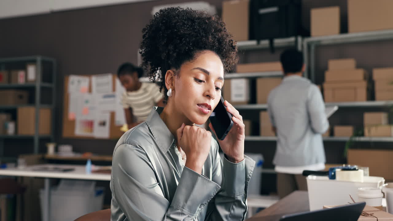 Professional Woman on Phone Call in Busy E-commerce Office