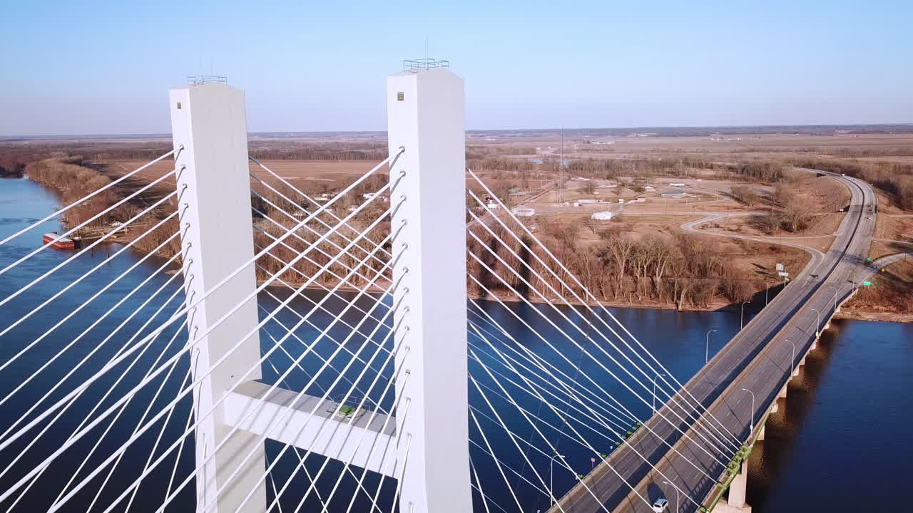 Aerial of a suspension bridge crossing the Mississippi River near Burlington Iowa suggests American infrastructure 4