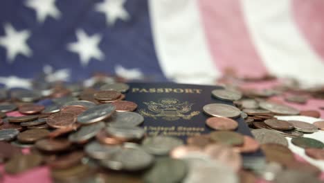 rack focus of coins over united states passport lay down at american flag