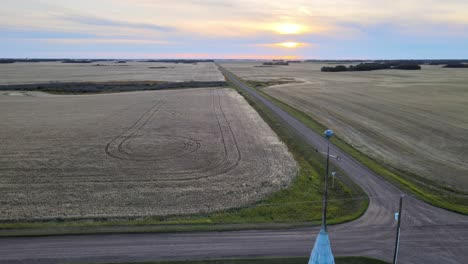 wide angle drone footage revealing a rustic lutheran church in the countryside of canada at sunset