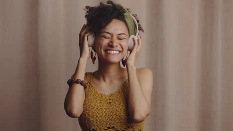 music lover. young stylish positive african american woman wearing headphones listening to music and dancing