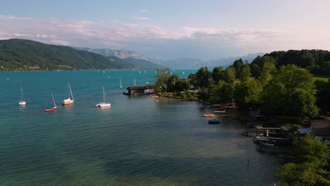 blue lake attersee in austria with clear water, alps mountains, sailing ship boat near idyllic scenic wolfgangsee, mondsee close to famous mozart city salzburg