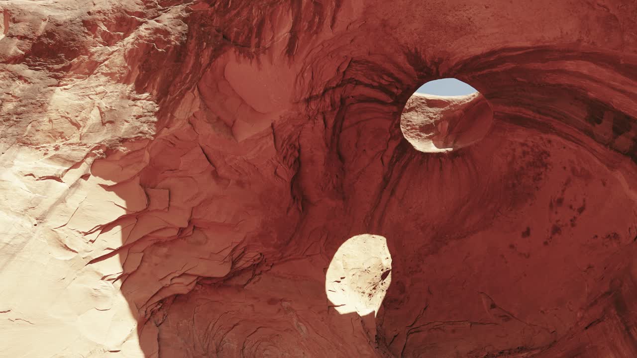 The beauty of cave eyes in the iconic Monument Valley, Utah. Explore the intricate natural rock formations of the cave as they blend seamlessly with the surrounding stunning desert landscape.