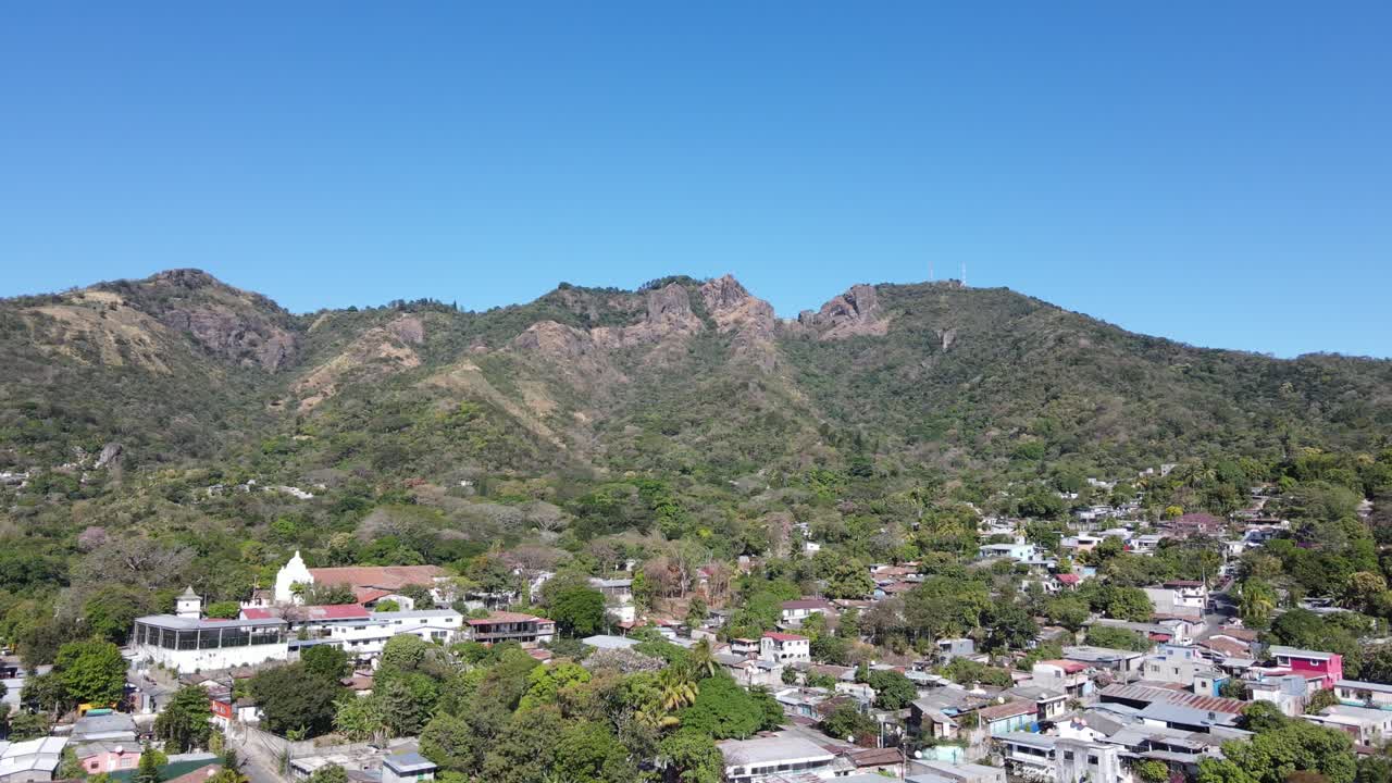 A picturesque village nestled on the slopes of a rocky mountain