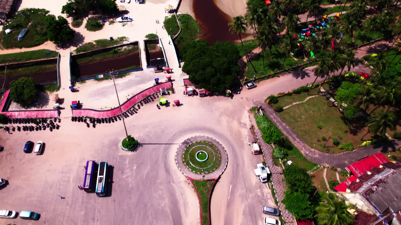 Reveal shot of Colva creek contamination colva beach with parking area and vehicles at goa. day time, push in, tilt up, drone shot, 4k