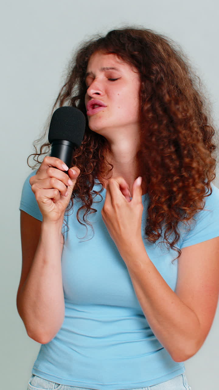 Woman enthusiastically singing into microphone expressive joyful performance musical vocal talent