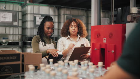 warehouse employees inspecting bottles