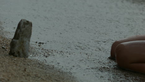 child playing in the waves on the beach