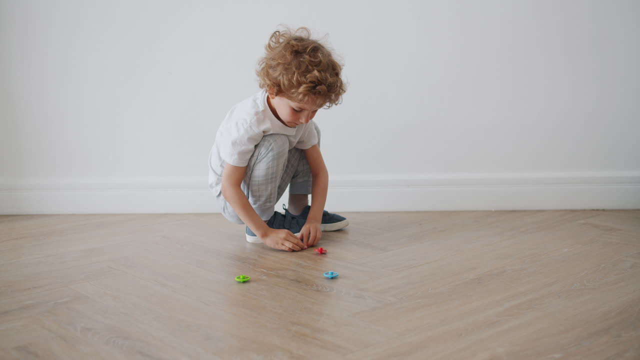 Child Playing with Spinning Tops